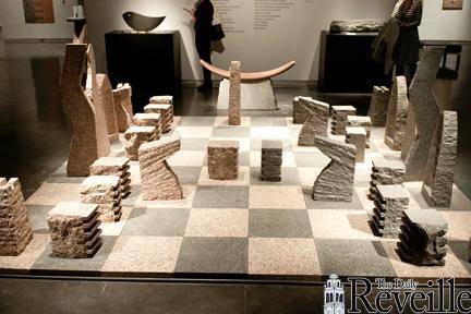 The Chess Club plays on a giant granite chess board Thursday at the LSU Museum of Art.