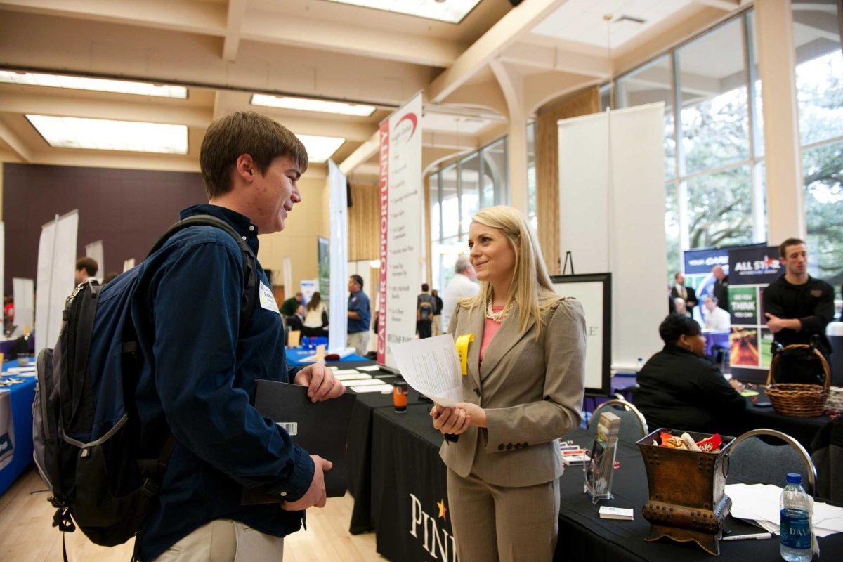 Robert Straus, general management junior, talks to Melissa Gebbia, executive assistant for Pinnacle Entertainment, about job opportunities at the 2011 Career Expo.