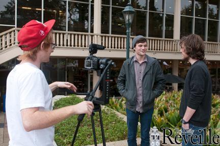 Digital art sophomores Hunter Esmon (left) and Andy Thompson (right) interview graphic design junior Derek Bonvillain on Monday outside the Union for a &#8220;Union Time&#8221; video.