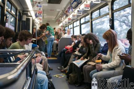 Students fill a campus bus and wait for its departure Monday at the bus stop outside of the Journalism Building. Students have been complaining about overcrowded buses.