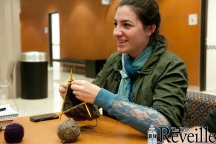 April Zola Emerson, history sophomore and member of the University club Yarn-aholics Anonymous, knits Feb. 1 at the organization&#8217;s meeting.