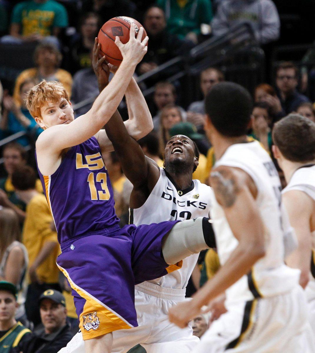 Oregon senior forward Jeremy Jacob fouls LSU junior forward Eddie Ludwig on Tuesday during the NIT in Eugene, Ore. The Ducks ended the Tigers&#8217; championship bid, 96-76.