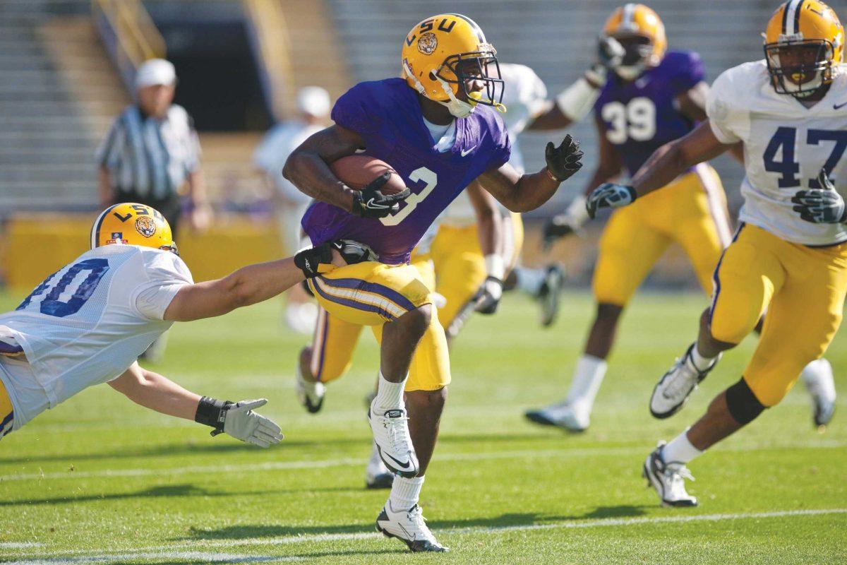 LSU freshman wide receiver Jakhari Gore (3) breaks a tackle April 9, 2011, during the second half of the spring game at Tiger Stadium.