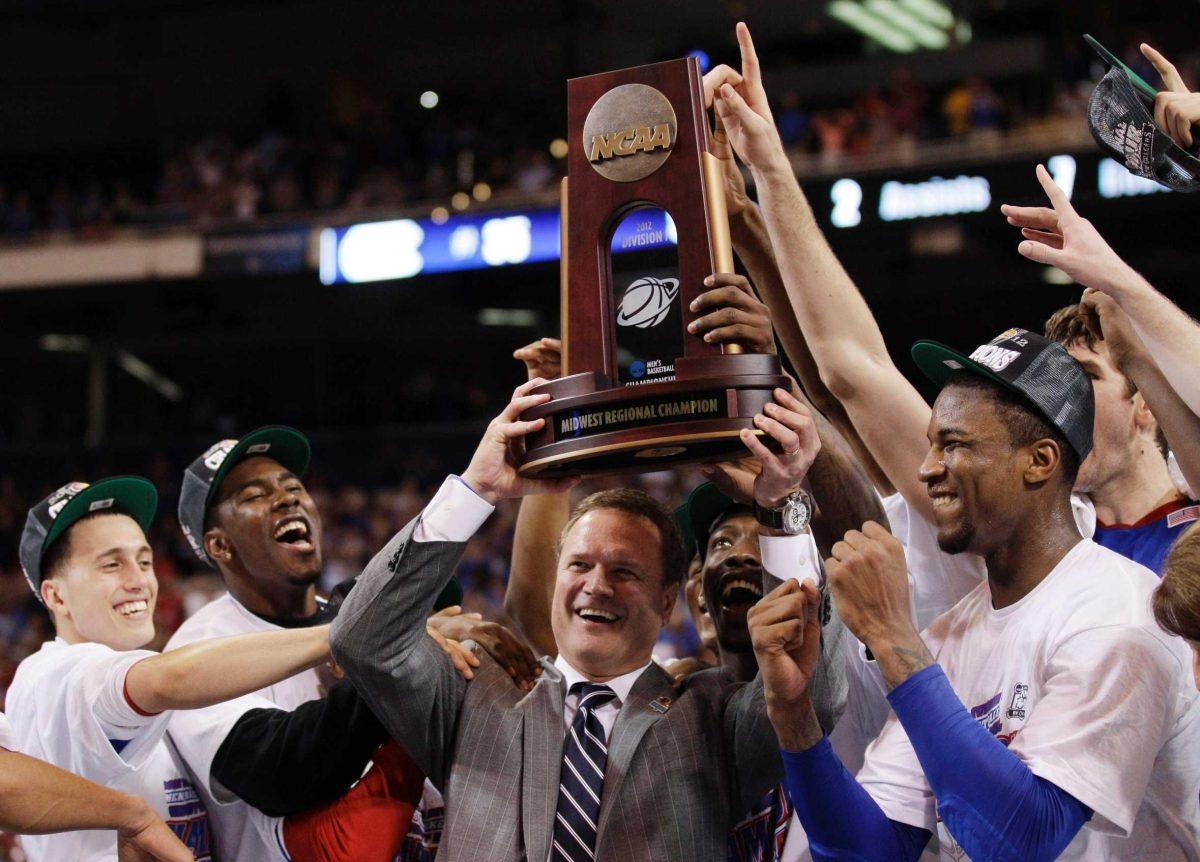 Kansas coach Bill Self and his team celebrate their 80-67 victory against North Carolina on Sunday in the NCAA tournament Midwest Regional final in St. Louis.