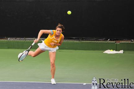 Junior Kaitlin Burns strikes a serve in her singles match Sunday against Auburn.