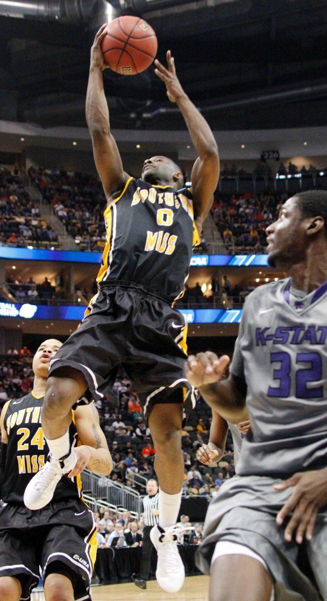 Southern Mississippi&#8217;s LaShay Page goes in to score behind Kansas State&#8217;s Jamar Samuels in the first half of an East Regional NCAA tournament game March 15.