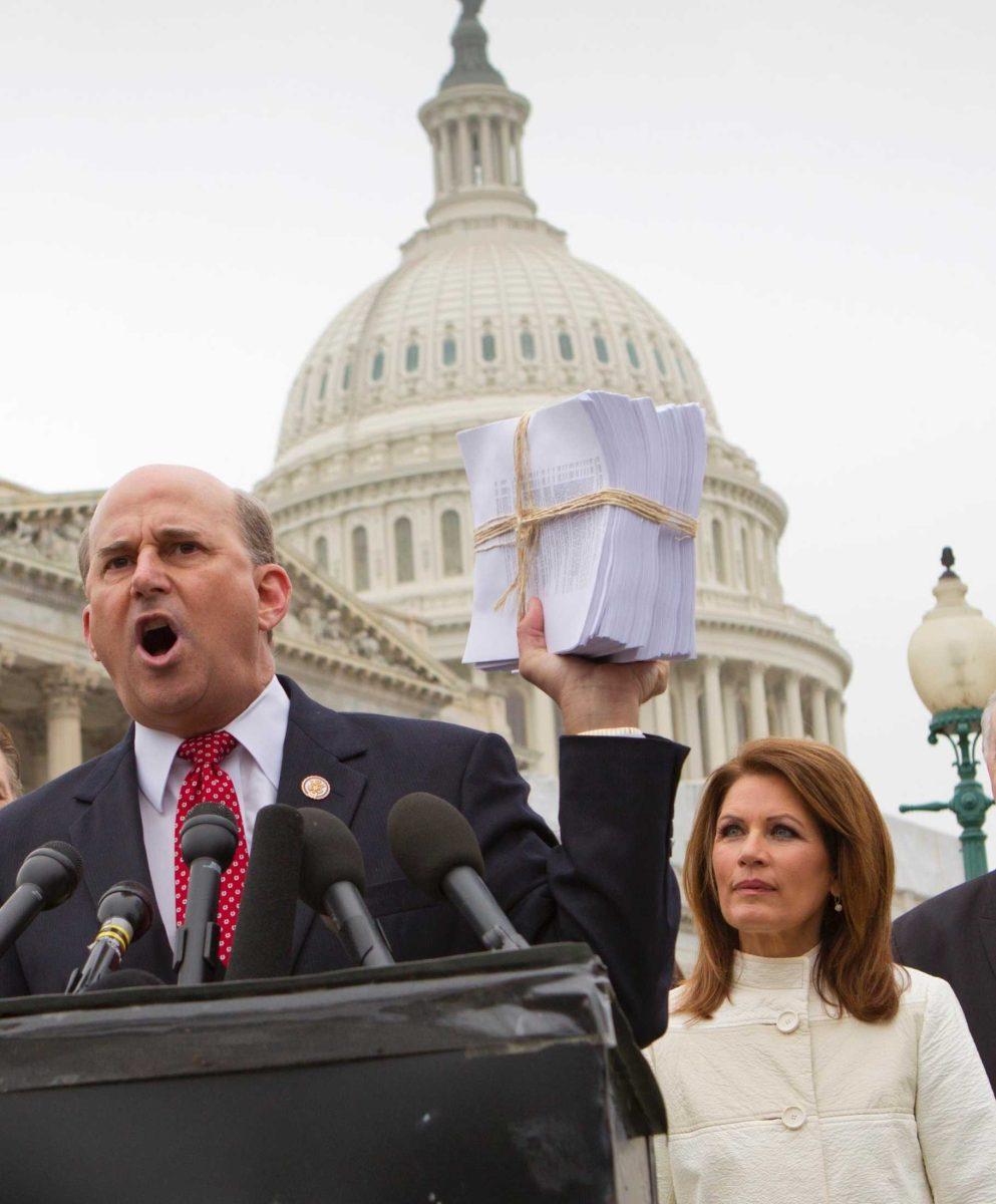 Rep. Louie Gohmert, R-Texas (left), holds up a copy of the Patient Protection and Affordable Care Act on March 21 on Capitol Hill.