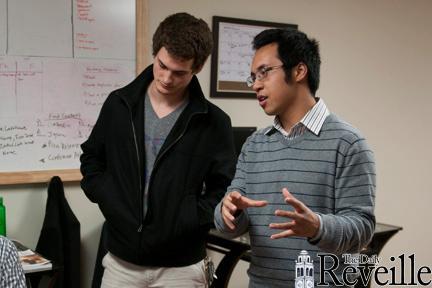 Graphic design junior Sam Claitor (left) and Big Fish CEO and marketing junior Kenny Nguyen (right) discuss balancing school and work Jan. 24 in the start-up&#8217;s office.