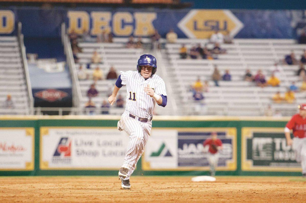 LSU senior third baseman Tyler Hanover sprints toward third base Wednesday during the Tigers&#8217; 5-4 victory against Lamar at Alex Box Stadium.