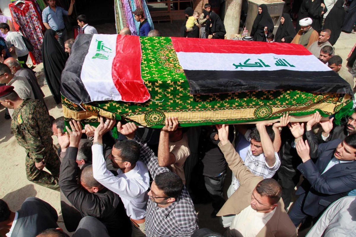 Mourners carry a coffin draped with Iraqi flags Saturday during the funeral procession for Shaima Alawadi in Najaf, Iraq.