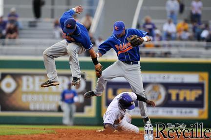 LSU junior outfielder Arby Fields safely slides under Louisiana College infielders to steal second base Tuesday at Alex Box Stadium. Tigers won, 10-2.