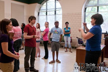 Mona Alkadi (right) shows Linguistics 4310 students sign language basics on March 30.