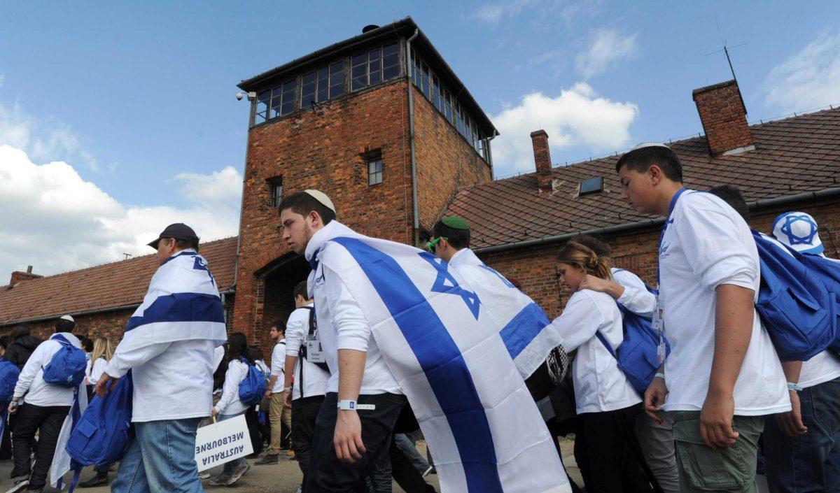 Participants in the March of the Living walk past a tower Thursday at the most notorious former Nazi Death Camp Auschwitz-Birkenau in southern Poland.