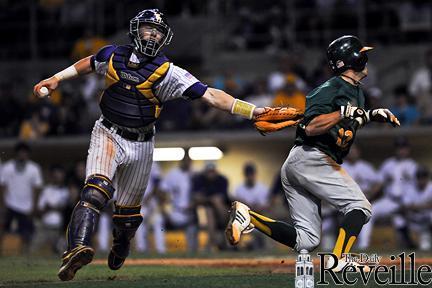 LSU sophomore catcher Ty Ross (26), left, tags Southeastern Louisiana infielder Brock Hebert (12), right, during the Tigers&#8217; 4-3 victory against the Lions.