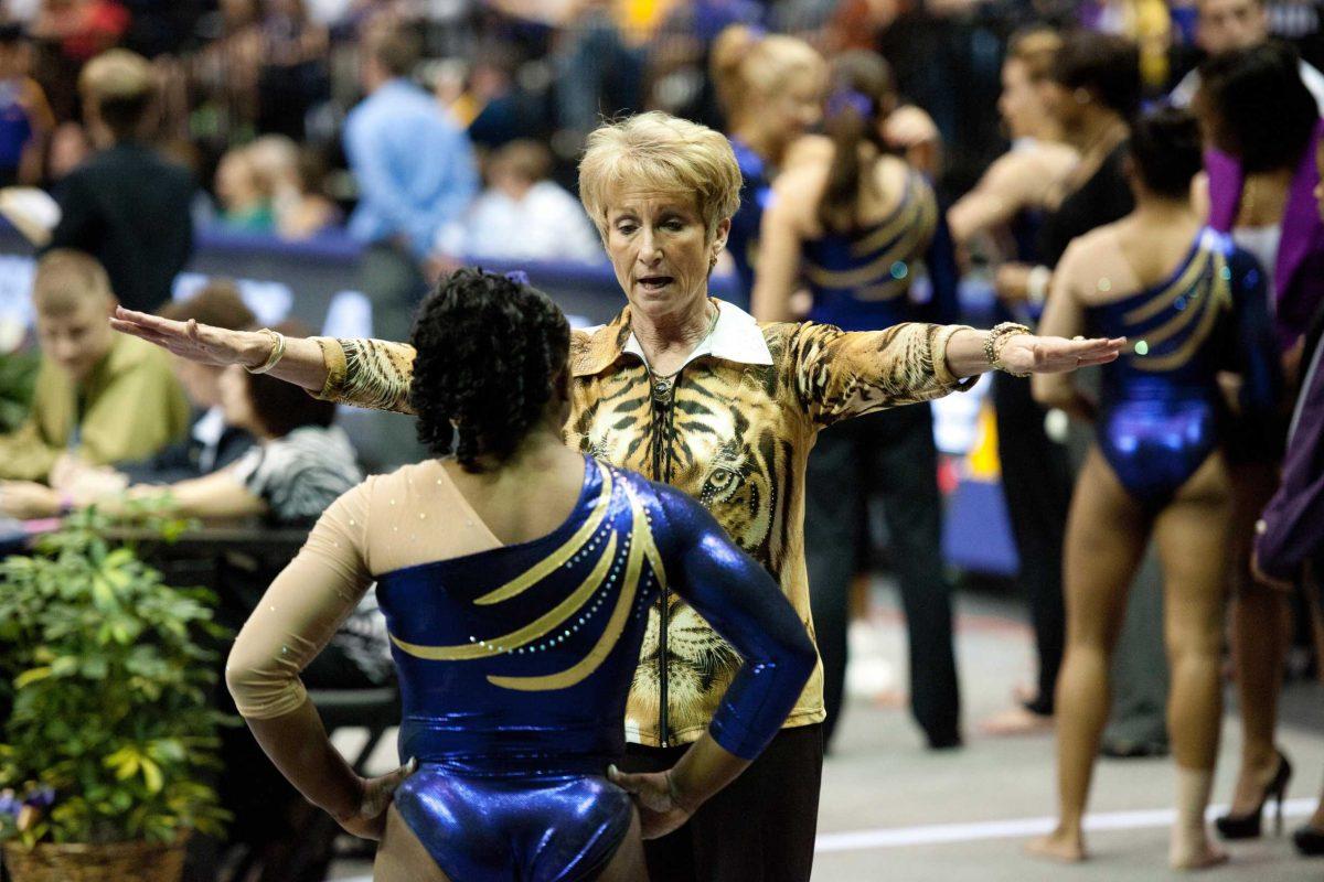 LSU gymnastics coach D-D Breaux speaks to freshman gymnast Lloimincia Hall on March 16 during the Tigers&#8217; meet against West Virginia in the PMAC.