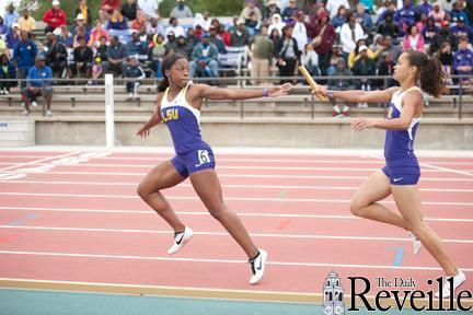 LSU freshman runner Samantha Levin (right) hands the baton to freshman Montenae Roye-Speight (left) on Saturday during the 4x400-meter relay at the LSU Alumni Gold Meet at Bernie Moore Track Stadium.