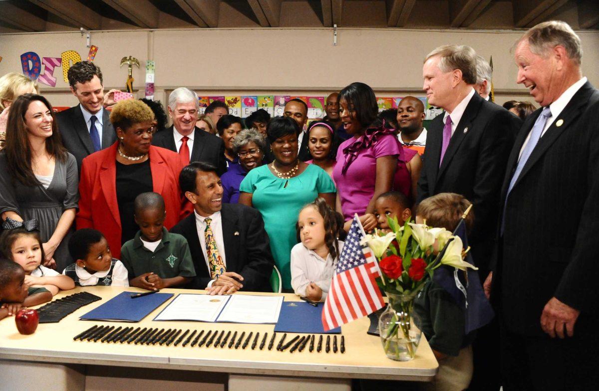 Gov. Bobby Jindal laughs on Wednesday at Redemptorist Elementary School in Baton Rouge as he signed three of his newly-passed bills to overhaul public school.