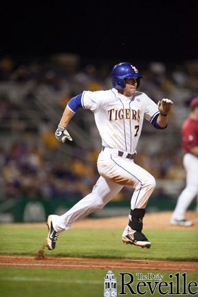 LSU senior infielder Grant Dozar sprints to first base Friday during the Tigers’ 10-6 win against Arkansas in Alex Box Stadium