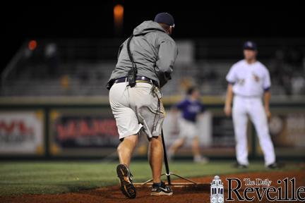 Groundskeepers hustle on and off the field, tending to the infield. Along with in-game care, the field must be ready five hours before the game.