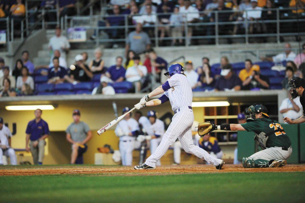 Junior outfielder Raph Rhymes winds up to hit the ball April 25 in the Tigers&#8217; victory against Southeaster in Alex Box Stadium.