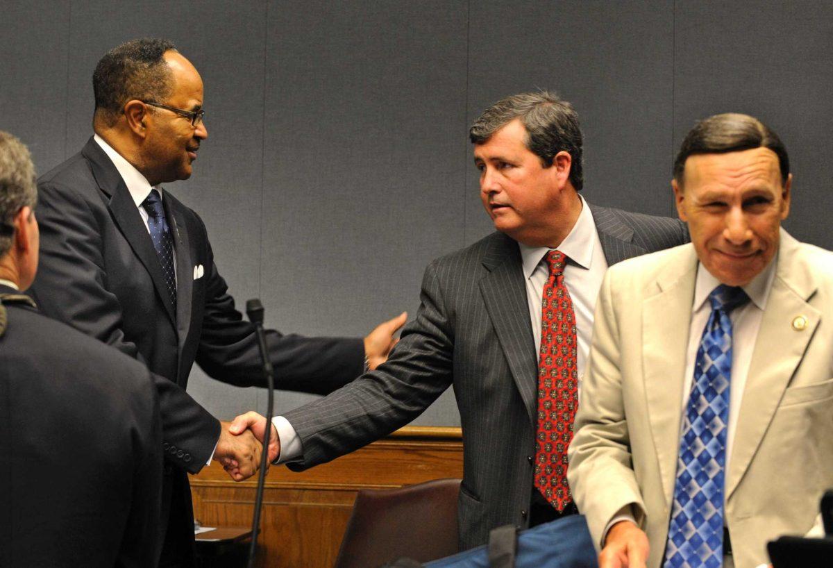 Sen. Neil Riser (center), R-Columbia, accepts congratulations from bill opponent Rep. Roy Burrell (left), D-Shreveport on Wednesday at the Louisiana State Capitol.