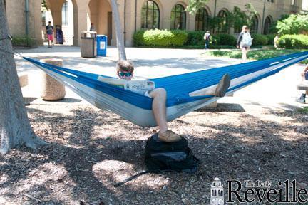 Erik Scharff, graphic design sophomore, relaxes in his hammock on April 23 in the Quad.