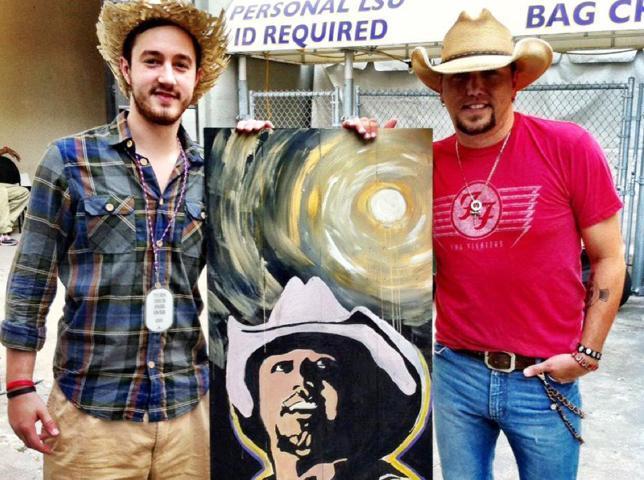 Zumo poses with Aldean May 27 at Bayou Country Superfest with Zumo&#8217;s portrait of the singer.