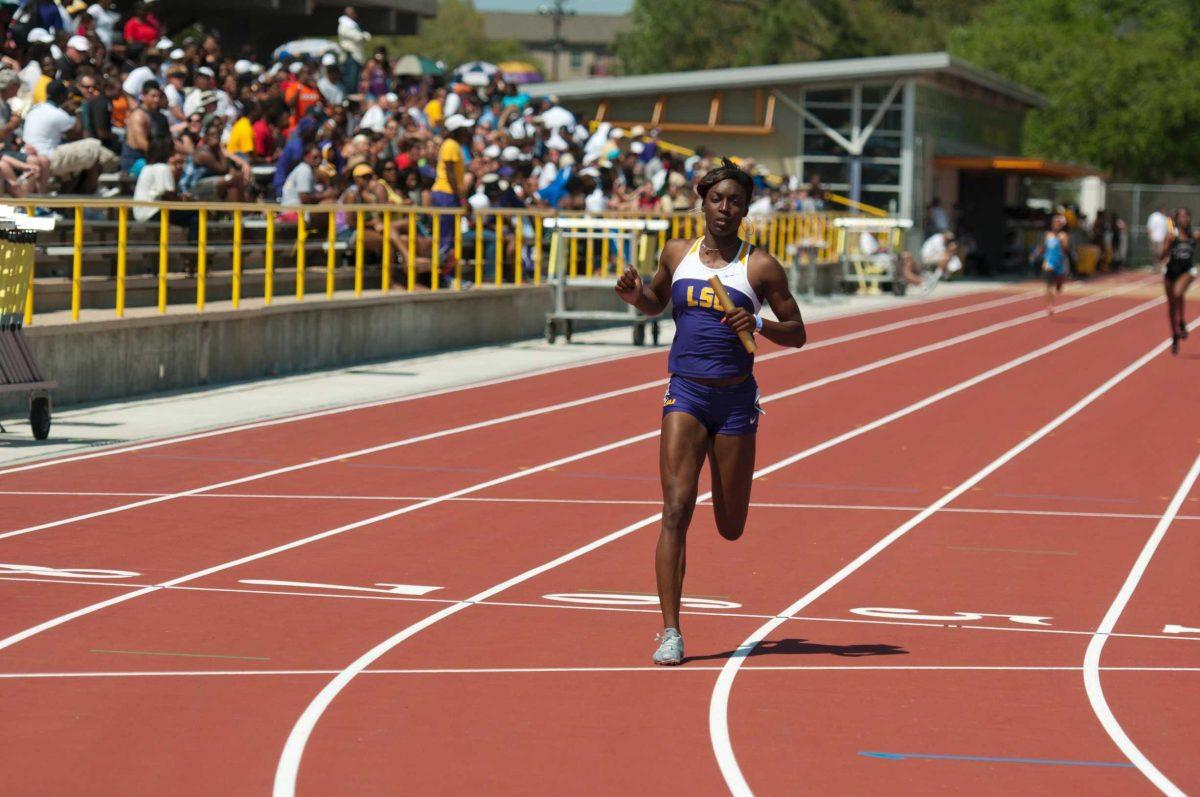 LSU senior sprinter Kimberlyn Duncan carries the baton in the anchor leg of a 4x200-meter relay during the LSU Relays in March at Bernie Moore Track Stadium.