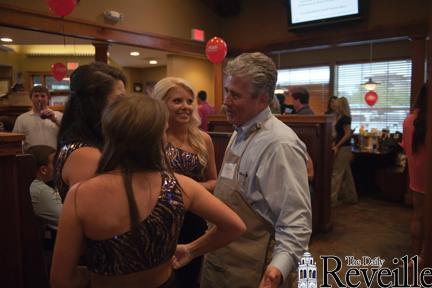 TAYLOR BALKOM / The Daily Reveille Bud Torres, Pointe Coupee sheriff, talks to The Golden Girls at Walk-On&#8217;s during its Celebrity Waiter Fundraiser, which supports the Children&#8217;s Advocacy Center.