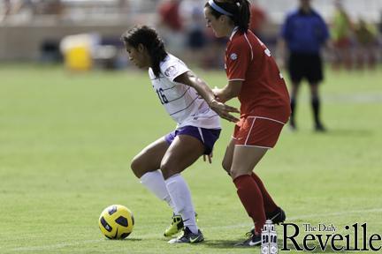 Senior Midfielder #16 Taryne Boudreau tries to avoid a Mississippi player.
 