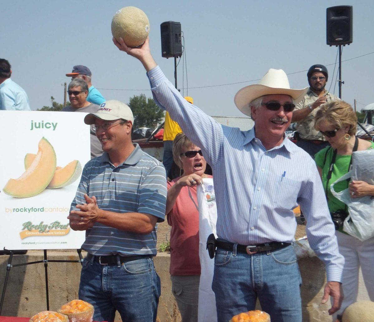 Colorado Agriculture Secretary John Salazar holds up a cantaloupe at the Arkansas Valley Fair in Rocky Ford, Colo., on Saturday.