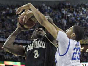 Kentucky forward Anthony Davis (23) blocks the shot of Vanderbilt center Festus Ezeli (3) during the first half of an NCAA college basketball game in the championship game of the Southeastern Conference tournament at the New Orleans Arena in New Orleans, Sunday, March 11, 2012. (AP Photo/Gerald Herbert) ORG XMIT: LADM115
 