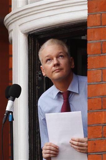 WikiLeaks founder Julian Assange looks up from the window of Ecuadorian Embassy Sunday in central London after making a statement to the media.