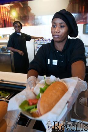 A French Quarter Caf&#233; employee hands a completed po-boy to a customer Friday upstairs in the Student Union.