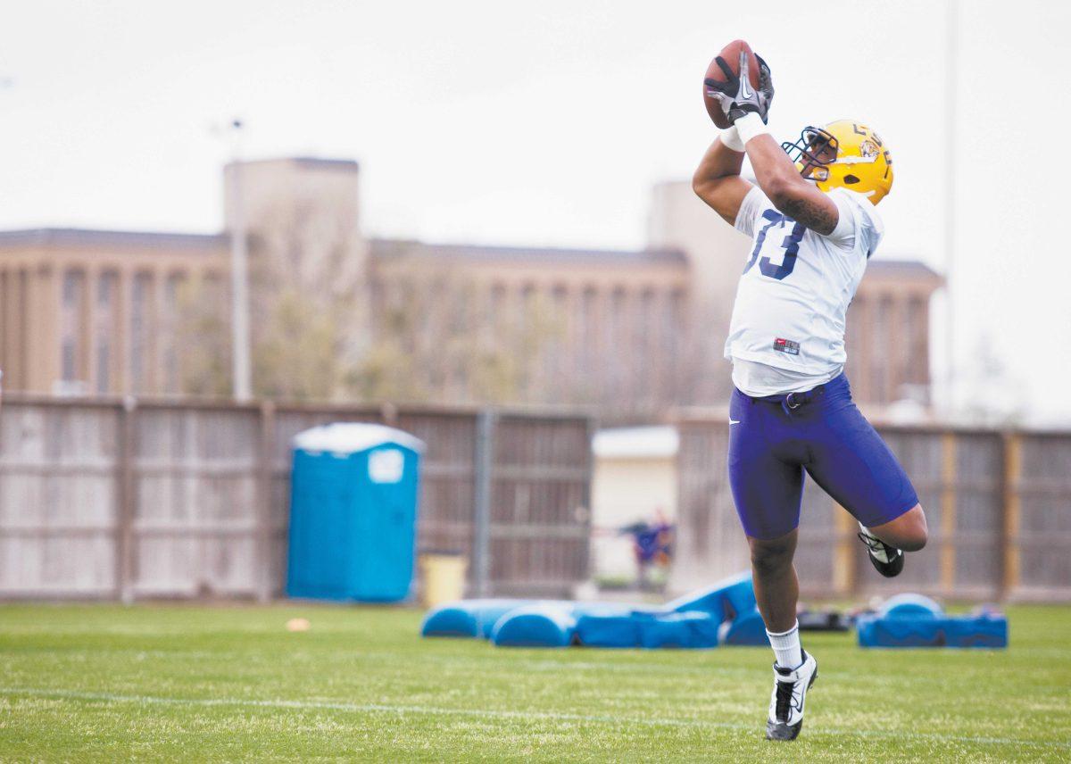 Freshman runningback Jeremy Hill catches a pass during a catching drill in the football team's first practice of the spring Friday.