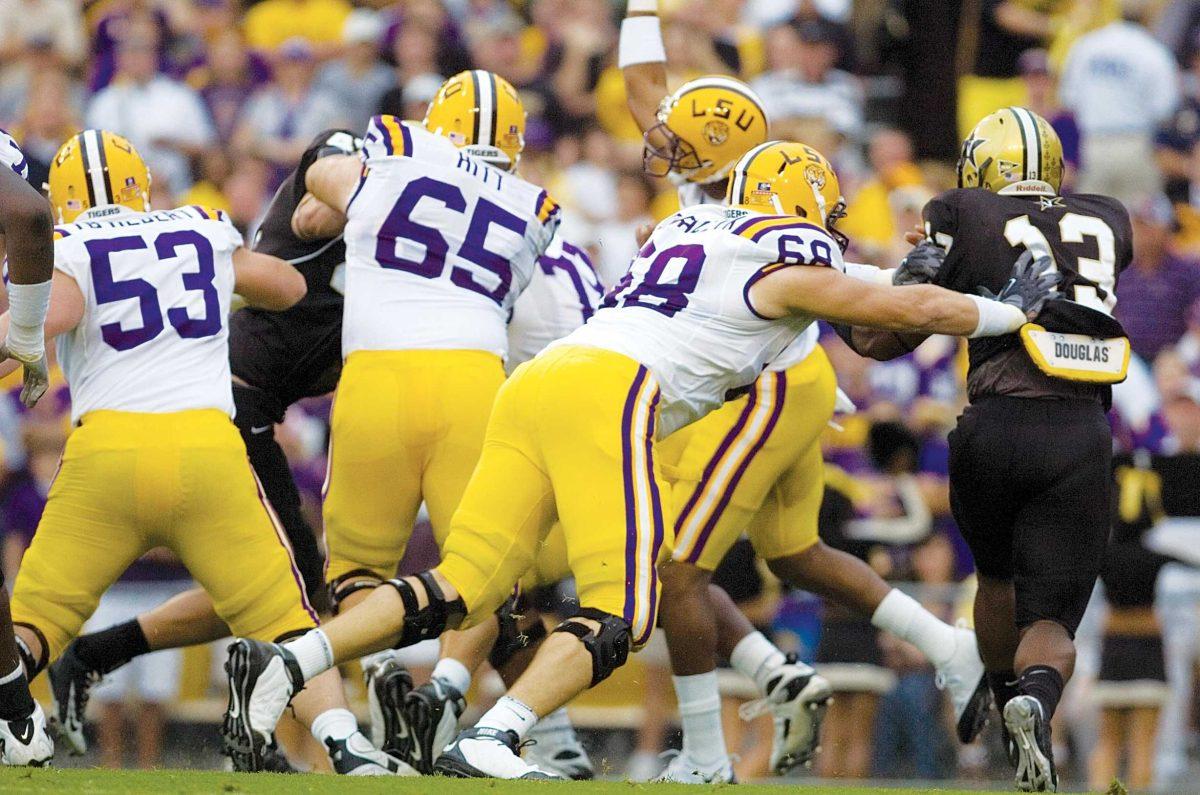 LSU offensive guard Josh Dworaczyk (68) tackles Vanderbilt linebacker Chris Marve on Sept. 11, 2010, in LSU&#8217;s 23-9 win in Tiger Stadium.