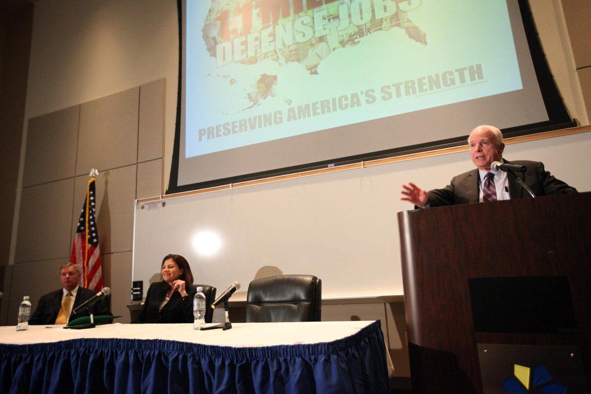 Sen. John McCain, R-Ariz., right, speaks at the College of Southern Nevada's Cheyenne campus in North Las Vegas on Monday, Aug. 13, 2012 during a town-hall style meeting to discuss looming cuts to defense spending. From left are Sen. Lindsey Graham, R-S.C., and Sen. Kelly Ayotte, R-N.H. The senators have visited other battleground states to pressure Democrats and President Barack Obama to make a budget deal to avoid automatic defense cuts over 10 years. (AP Photo/Las Vegas Review-Journal, Jessica Ebelhar)