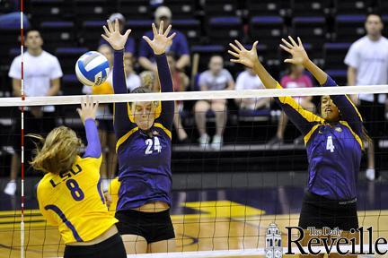 LSU sophomore outside hitter Helen Boyle (8) spikes it past LSU freshman right side outside hitter Cati Leak (24) and LSU junior middle blocker Desiree Elliott (4) on Saturday in the Pete Maravich Assembly Center in the Purple and Gold Scrimmage.
 