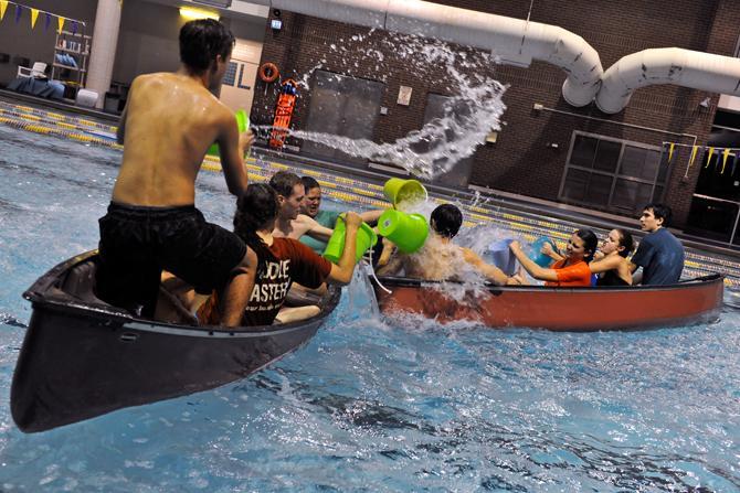 Teams participate in a round of Battleship, a new intramural at the UREC, Sunday in the UREC pool. Teams of four compete in a canoe and use buckets or other containers to throw water and sink other canoes.
 