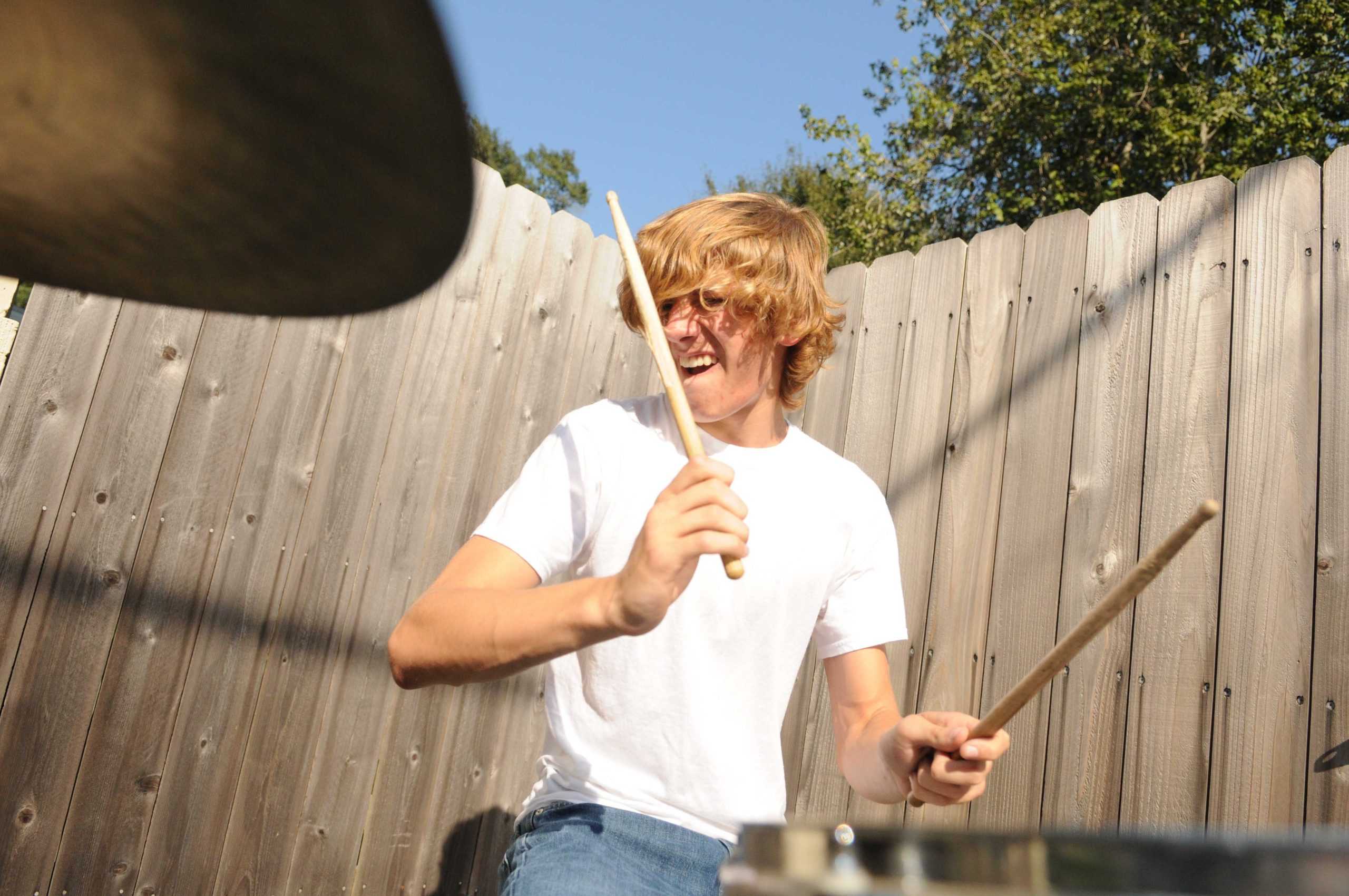 Shirtless high school band serenades drivers on Highland