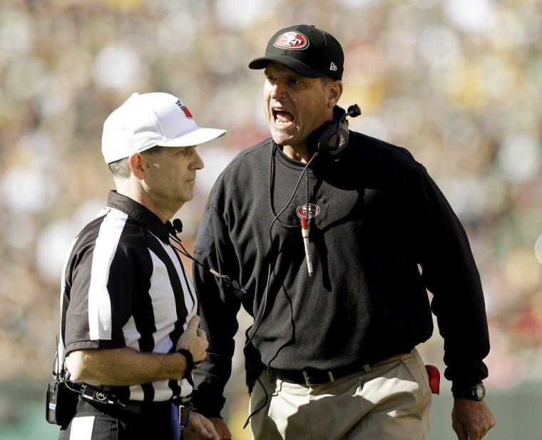 San Francisco 49ers head coach Jim Harbaugh argues a call with referee David White during the first half of an NFL football game against the Green Bay Packers Sunday, Sept. 9, 2012, in Green Bay, Wis. (AP Photo/Jeffrey Phelps)
 