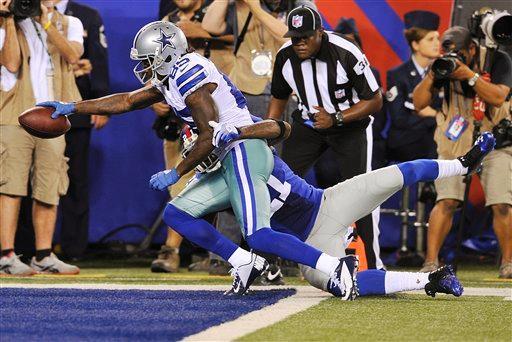 Dallas Cowboys wide receiver Kevin Ogletree (85) scores a touchdown Wednesday night as New York Giants strong safety Kenny Phillips (21) defends during the second half of the 2012 NFL season opener.