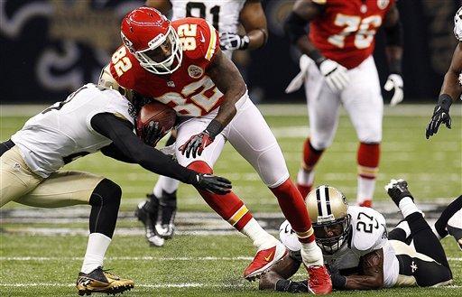 Kansas City Chiefs wide receiver Dwayne Bowe (82) is tackled by New Orleans Saints free safety Malcolm Jenkins (27) and cornerback Patrick Robinson (21) in the first half of an NFL football game in New Orleans, Sunday, Sept. 23, 2012. (AP Photo/Bill Haber)
 