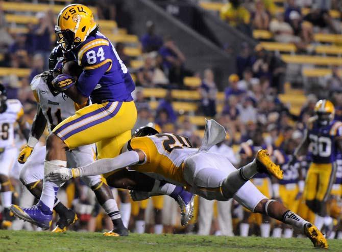 Sophomore tight end Nic Jacobs dodges a defender during the Sept 29. game against Towson University.
 