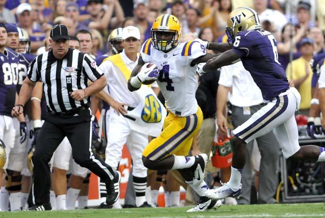 LSU junior running back Alfred Blue (4) fights off Washington senior cornerback Desmond Trufant (6) Saturday Sept. 8, 2012 during the Tigers' 41-3 victory over the Washington Huskies in Tiger Stadium.
 