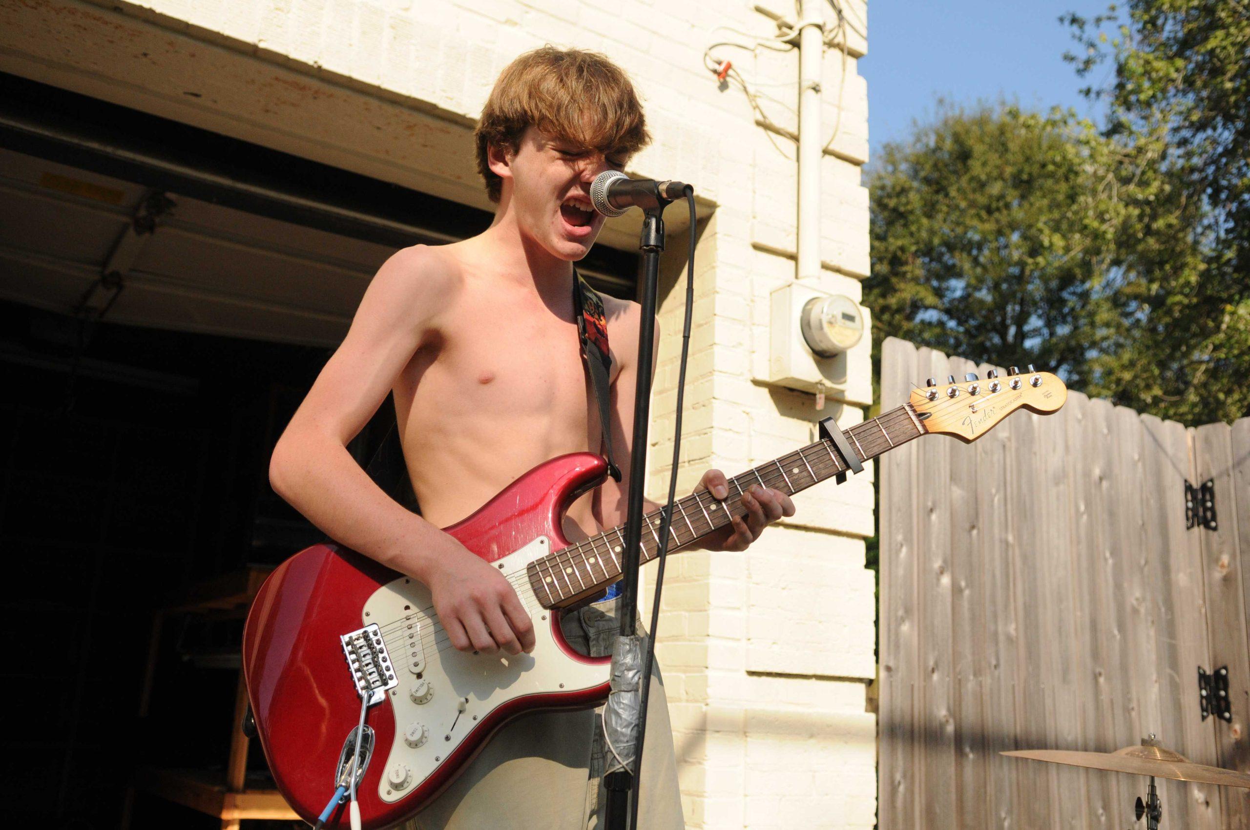 Shirtless high school band serenades drivers on Highland