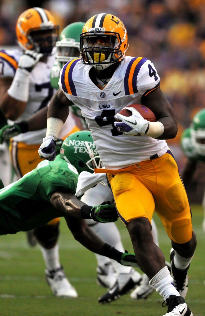 LSU junior running back Alfred Blue (4) slips past a North Texas defender in Saturday's game vs North Texas in Tiger Stadium. Saturday, Sept. 1, 2012.