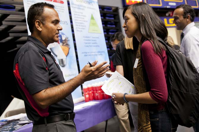 Petroleum engineer senior Citra Inaray, right, speaks with a representative from WorleyParsons on Wednesday at the career expo held in the PMAC.
 