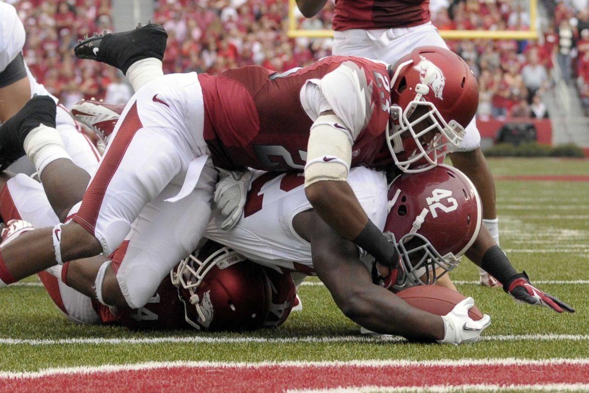 <p>Alabama running back Eddie Lacy (42) scores on a 6-yard touchdown run as Arkansas cornerback Kaelon Kelleybrew (23) tried to stop him during first quarter action of an NCAA college football game in Fayetteville, Ark., Saturday, Sept. 15, 2012 (AP Photo/David Quinn)</p>