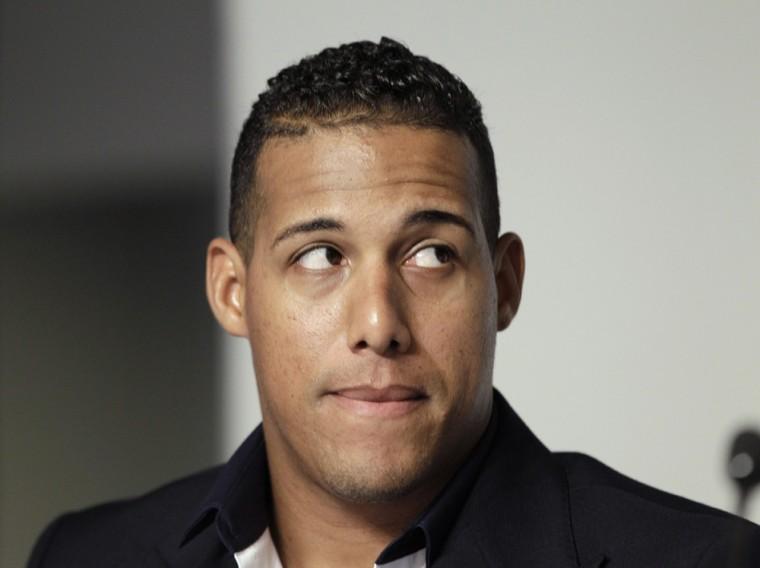 Toronto Blue Jays' Yunel Escobar speaks to reporters at Yankee Stadium in New York, Tuesday, Sept. 18, 2012. Escobar was suspended for three games Tuesday by the Blue Jays for wearing eye-black displaying a homophobic slur written in Spanish during last Saturday's game against the Boston Red Sox. (AP Photo/Kathy Willens)
 